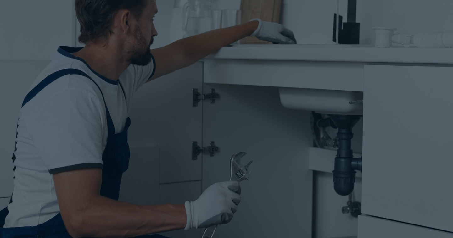 Plumber under sink inspection